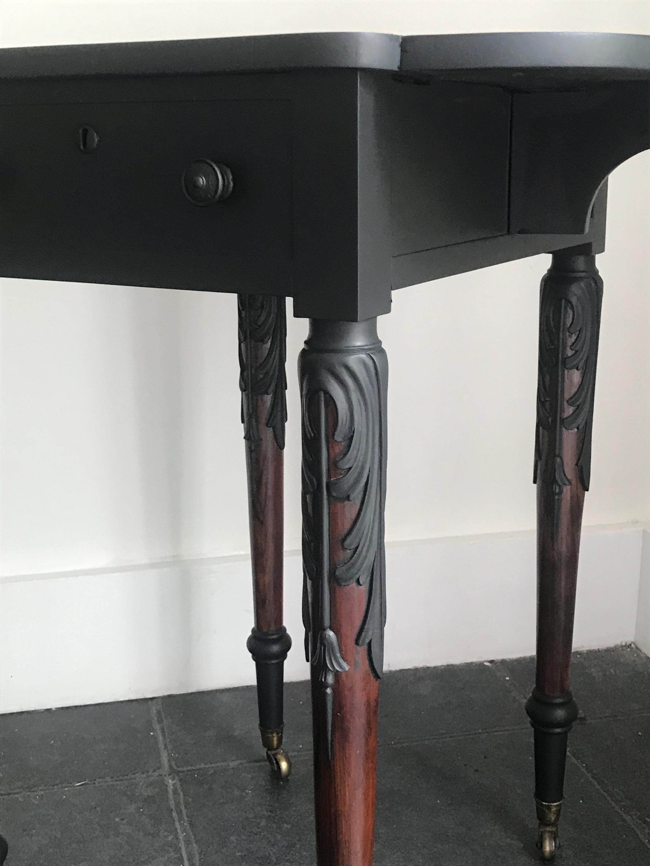 Elegant Antique  Black  Ornate Carved Table with antique casters.