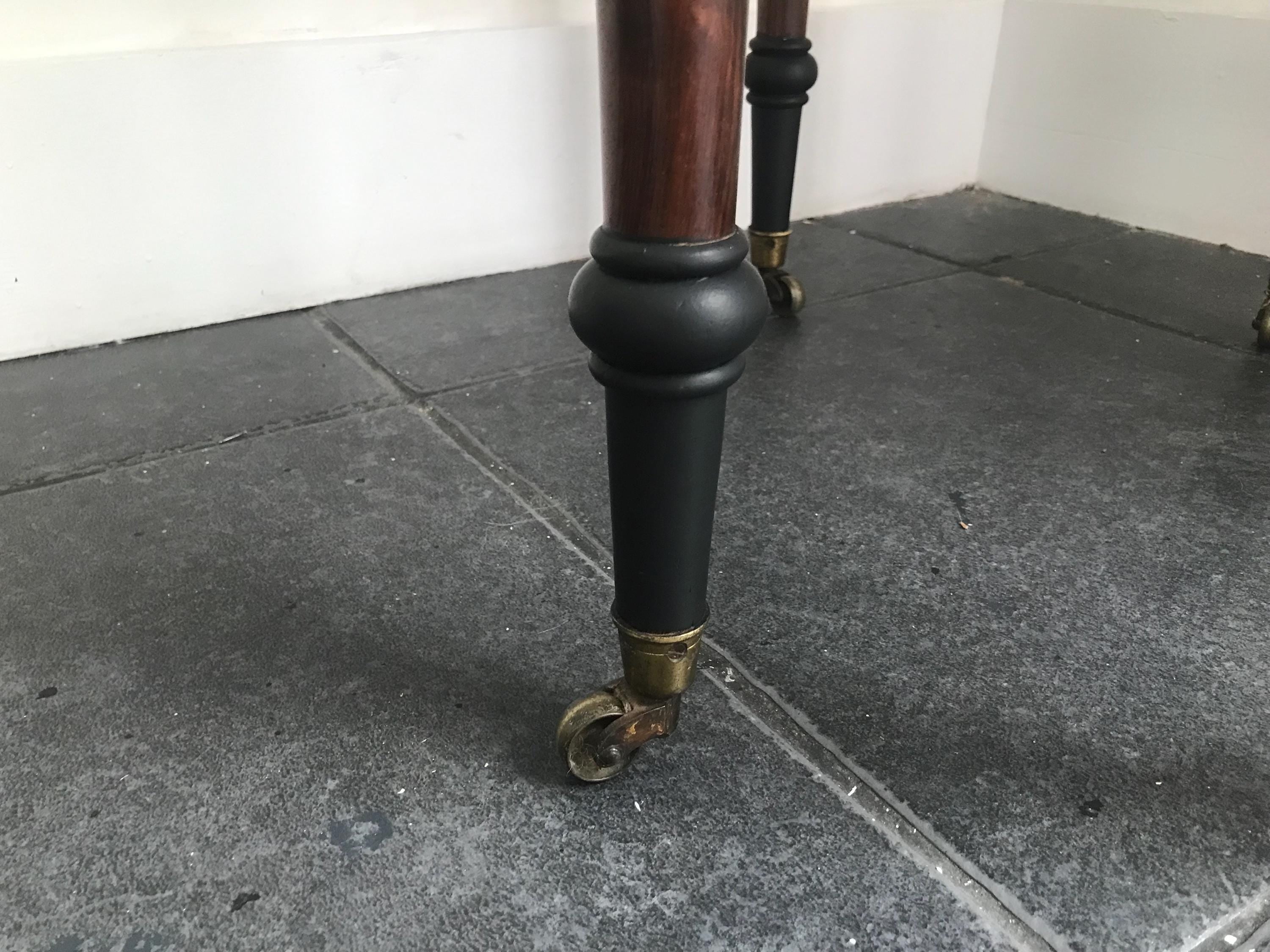 Elegant Antique  Black  Ornate Carved Table with antique casters.