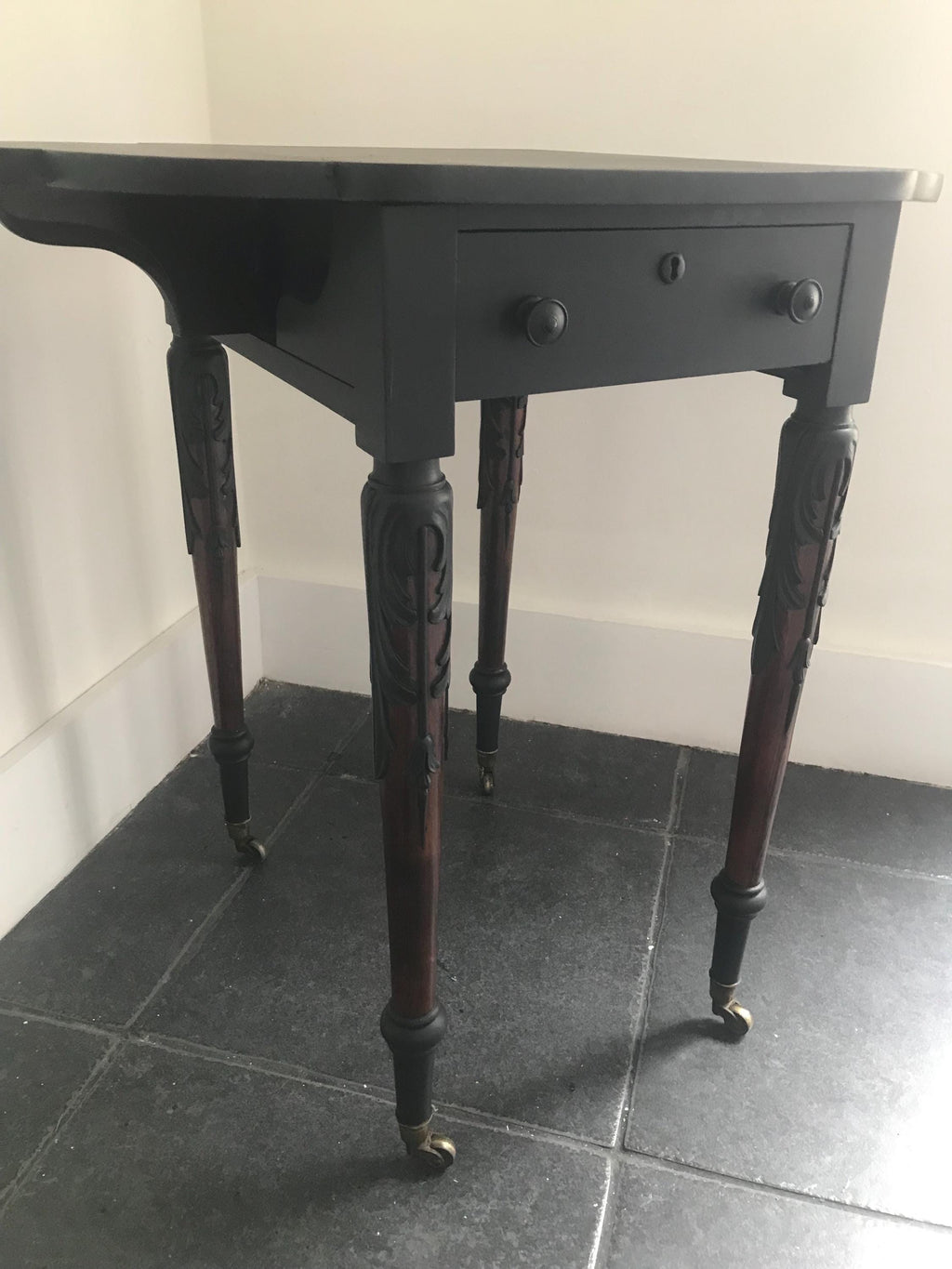 Elegant Antique  Black  Ornate Carved Table with antique casters.
