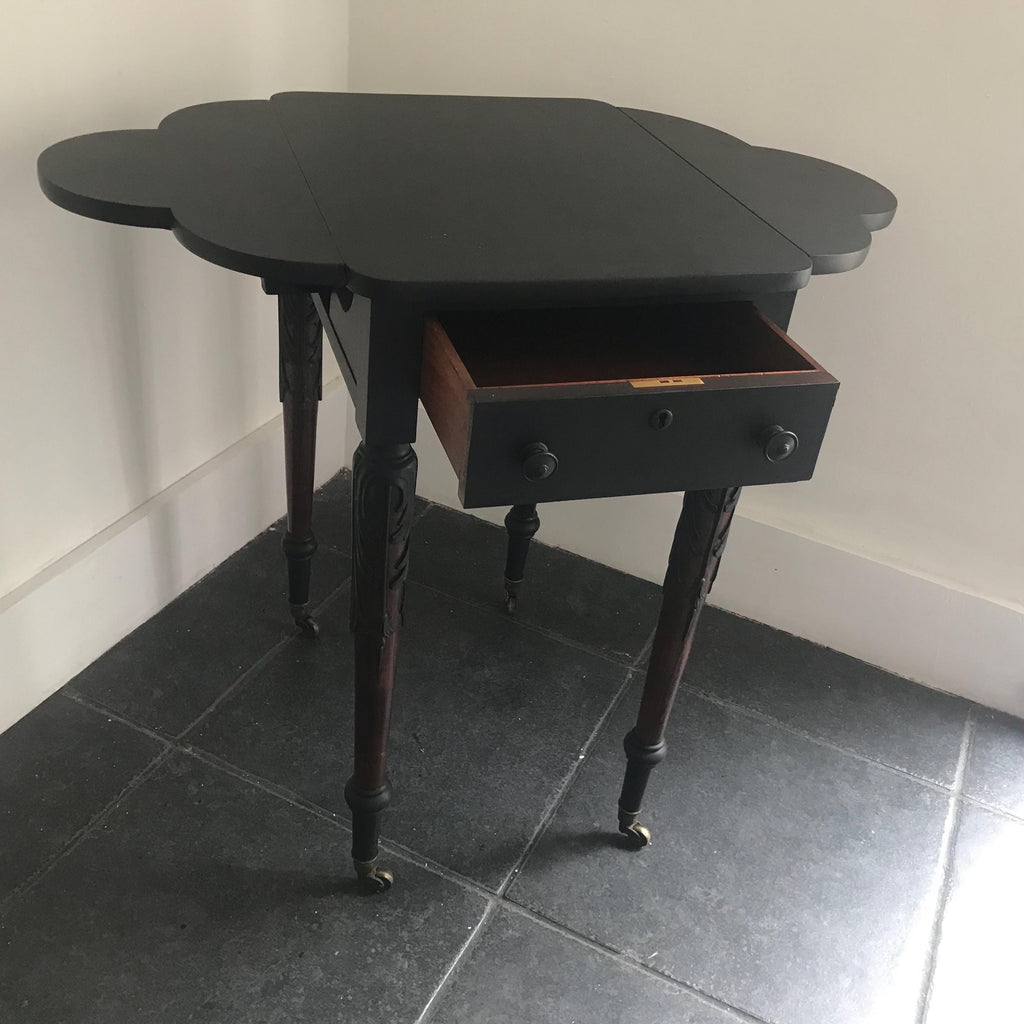 Elegant Antique  Black  Ornate Carved Table with antique casters.