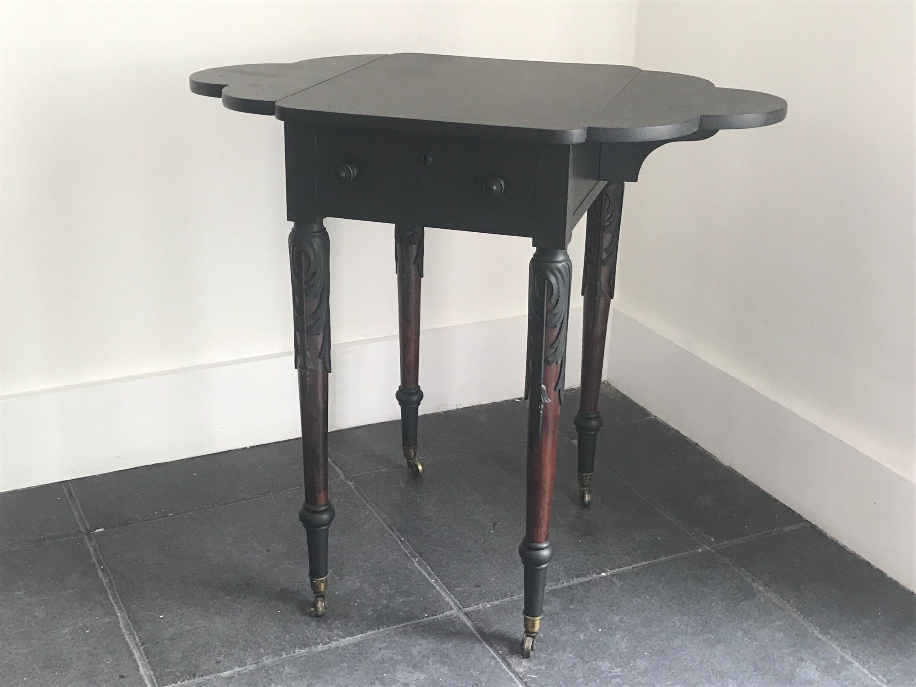 Elegant Antique  Black  Ornate Carved Table with antique casters.